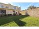 View of the backyard and second story balcony area on a sunny day at 11001 Se Sunset Harbor Rd # F45, Summerfield, FL 34491