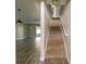 Hallway with a carpeted staircase and view into the main living area at 11001 Se Sunset Harbor Rd # F45, Summerfield, FL 34491