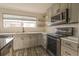 Bright kitchen featuring stainless steel appliances, a breakfast bar, and white subway tile at 11001 Se Sunset Harbor Rd # F45, Summerfield, FL 34491