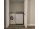 Convenient laundry room with a washer and dryer, enclosed by white double doors at 11001 Se Sunset Harbor Rd # F45, Summerfield, FL 34491