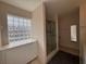 Bathroom featuring a glass block window, shower, and vanity with cabinets at 11147 Sw 68Th Ct, Ocala, FL 34476