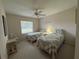 Bedroom featuring two beds, a window, and a ceiling fan at 11147 Sw 68Th Ct, Ocala, FL 34476