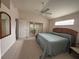 Bright bedroom with a ceiling fan, carpet, and natural light coming through the window at 11147 Sw 68Th Ct, Ocala, FL 34476