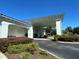 Exterior shot of the Palm Grove Club with lush greenery and palm trees at 11147 Sw 68Th Ct, Ocala, FL 34476