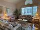 Bright living room with large window and comfortable seating arrangements at 11147 Sw 68Th Ct, Ocala, FL 34476