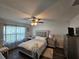 Primary bedroom with a ceiling fan and large windows at 12495 Se 102Nd Ave, Belleview, FL 34420