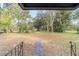 Large backyard with a grassy area and mature trees at 217 Nw 14Th St, Ocala, FL 34475