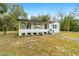 Renovated home with a front porch and a tree-filled landscape at 217 Nw 14Th St, Ocala, FL 34475