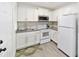 White kitchen with stainless steel appliances at 217 Nw 14Th St, Ocala, FL 34475