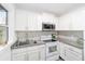 Bright kitchen with white cabinets, granite counters, and stainless steel appliances at 217 Nw 14Th St, Ocala, FL 34475