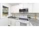 Updated kitchen featuring white shaker cabinets and granite countertops at 217 Nw 14Th St, Ocala, FL 34475