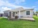 Rear view of house showing patio, pergola, and landscaped yard at 2360 Hopespring Loop, The Villages, FL 32162