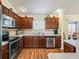 Kitchen with stainless steel appliances and wood cabinets at 2360 Hopespring Loop, The Villages, FL 32162