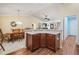 Kitchen with island, wood cabinets, and dining area at 2360 Hopespring Loop, The Villages, FL 32162