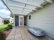 Backyard patio featuring pergola, tile flooring and storage container at 2360 Hopespring Loop, The Villages, FL 32162