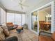 Bright sunroom with wicker furniture and view of dining room at 2360 Hopespring Loop, The Villages, FL 32162