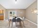 Dining room with a modern white table and gray chairs, and access to backyard at 3720 Se 24Th St, Ocala, FL 34471