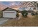 White single-story house with attached garage, and a well-maintained lawn at 3720 Se 24Th St, Ocala, FL 34471