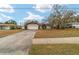 Front view of a house with a driveway and mature trees at 3720 Se 24Th St, Ocala, FL 34471