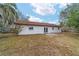 Back exterior view of the house, showing a patio and yard at 3720 Se 24Th St, Ocala, FL 34471