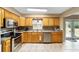 Kitchen with light wood cabinets, stainless steel appliances, and a view of the backyard at 3720 Se 24Th St, Ocala, FL 34471