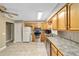 Kitchen with light wood cabinets, stainless steel appliances, and granite countertops at 3720 Se 24Th St, Ocala, FL 34471