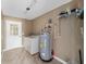 Laundry room with washer, dryer, and hot water heater at 3720 Se 24Th St, Ocala, FL 34471