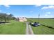 Aerial view of a house on a large lot with a pond and lush green pastures at 4027 N C 470, Lake Panasoffkee, FL 33538