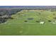 Aerial view of a home and expansive green fields at 4027 N C 470, Lake Panasoffkee, FL 33538