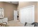 Bedroom with white closet doors and view into another room at 4027 N C 470, Lake Panasoffkee, FL 33538