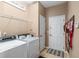 Laundry room with washer, dryer, and storage shelves at 4027 N C 470, Lake Panasoffkee, FL 33538