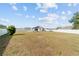 Expansive backyard view highlighting the pool and surrounding green space, complete with a privacy fence at 4812 Se 37Th St, Ocala, FL 34480