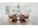 Charming dining room with neutral tones, a wooden table set, and natural light from large windows at 4812 Se 37Th St, Ocala, FL 34480