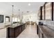 Open kitchen with large island, stainless steel appliances, granite countertops, and access to the living and dining area at 4812 Se 37Th St, Ocala, FL 34480