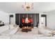 Stylish living room with a fireplace, comfortable seating, and modern decor with an elegant light fixture at 4812 Se 37Th St, Ocala, FL 34480