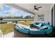 Covered patio featuring a stylish curved couch, ceiling fan and overlooking the pool at 4812 Se 37Th St, Ocala, FL 34480