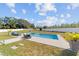 Relaxing pool area with lounge chairs, lush green lawn, and inviting blue water at 4812 Se 37Th St, Ocala, FL 34480