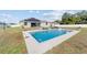 Beautiful rectangular pool with solar panels on the roof, backyard patio furniture, and privacy fence at 4812 Se 37Th St, Ocala, FL 34480