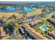 Aerial view of a community with lake, golf course, and pool at 506 Fairways Cir # B, Ocala, FL 34472