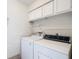 Laundry area with washer, dryer, and cabinets at 506 Fairways Cir # B, Ocala, FL 34472