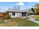 Single story home with gray roof and landscaped yard at 6292 Se 87Th St, Ocala, FL 34472