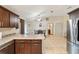 Open concept kitchen and dining area with stainless steel appliances and tile flooring at 6292 Se 87Th St, Ocala, FL 34472