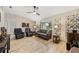 Living room with hardwood floors, ceiling fan, and comfy seating at 6292 Se 87Th St, Ocala, FL 34472