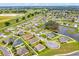 Aerial view of a residential neighborhood, showcasing manicured lawns and community pond at 6407 Sw 45Th Ave, Ocala, FL 34474