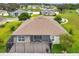 Aerial view of a home highlighting its screen enclosed lanai and community landscape at 6407 Sw 45Th Ave, Ocala, FL 34474