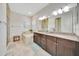 Bathroom features a double vanity with granite countertops, soaking tub, and glass-enclosed shower at 6407 Sw 45Th Ave, Ocala, FL 34474