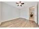 Neutral bedroom with ceiling fan, closet and wood floors creates a serene atmosphere at 6407 Sw 45Th Ave, Ocala, FL 34474