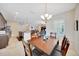 Dining room with a modern chandelier, dark wood table and seating, and tile floors provides an open airy feel at 6407 Sw 45Th Ave, Ocala, FL 34474