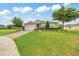 Welcoming single-story home showcasing a lush green lawn, long driveway, and a convenient two-car garage at 6407 Sw 45Th Ave, Ocala, FL 34474