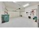Clean, epoxy floored garage with organized storage, shelving and space for two cars at 6407 Sw 45Th Ave, Ocala, FL 34474